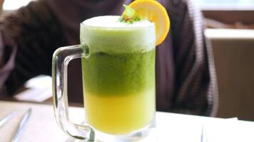 A green drink with a lemon slice on top video