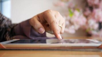 A person is using a tablet computer with their finger video