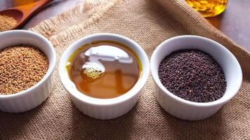 Three bowls of different types of seeds sit on a table video
