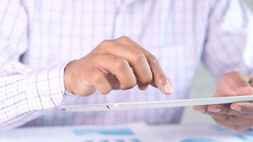 A man is using a tablet computer with his hand video