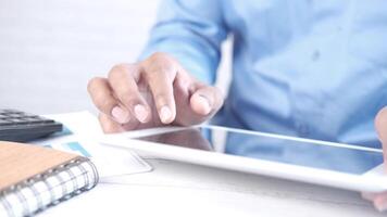 A person is using a tablet computer with a calculator video
