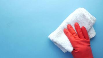 A person in red gloves and red rubber gloves cleaning a white cloth video