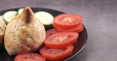A plate with a sandwich, cucumbers and tomatoes video