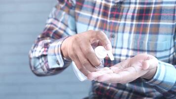 A man is holding a bottle of hand sanitizer video