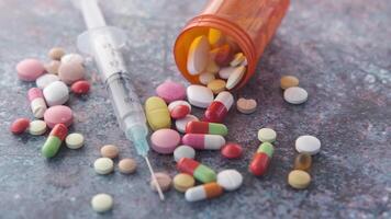 Pills and syringe on a table video