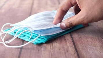 A person is putting a surgical mask on a table video