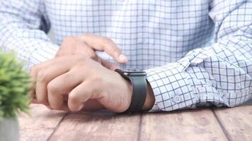 A man is checking his watch on a table video
