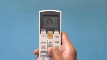 A person holding a remote control with the number 2 on it video