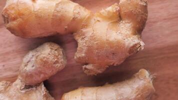 Ginger root on a wooden surface video