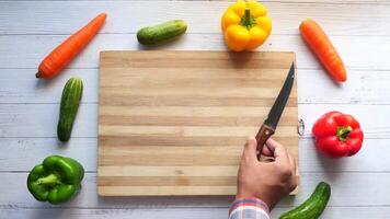 A person cutting vegetables on a cutting board video