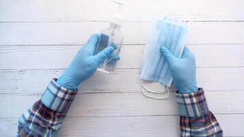 A person wearing blue gloves and a mask video