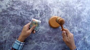 Money and judge's gavel on marble background video
