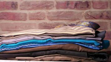 A stack of folded clothes sitting on a table video