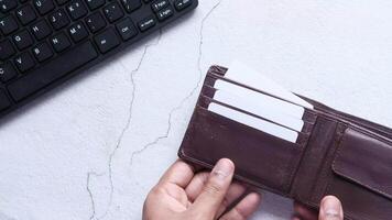 A person holding a wallet with a credit card in it video