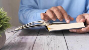A person is reading a book on a table video