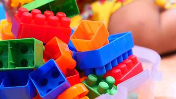 A child playing with colorful plastic blocks video