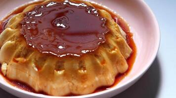 A bowl of pudding with sauce on top video