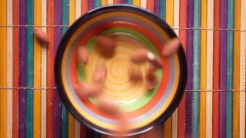 A colorful bowl with nuts on it video