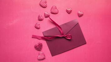 A pink envelope with a ribbon and hearts on a pink background video