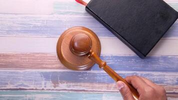 Judge gavel on wooden table with book and pen video