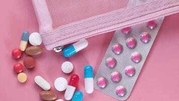 Pills and pills in a plastic bag on a pink background video