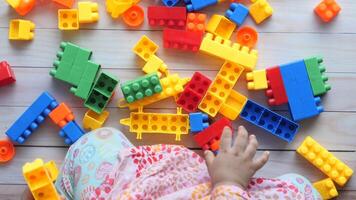 A child's hands are surrounded by colorful blocks video