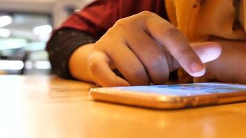 A person using a cell phone on a table video
