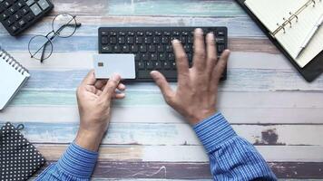 A man's hands are on a keyboard and a credit card video