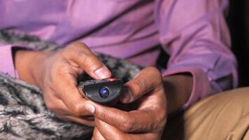 A man holding a remote control in his hand video