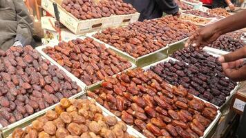 A man is looking at a variety of dates video