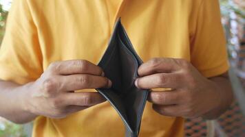 A man holding an empty wallet video