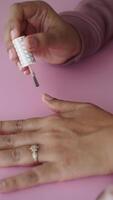 vertical shot of putting nail polish on nail , video