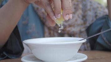 Squeezing a Fresh Lemon into a Bowl of Delicious Soup for Enhanced Flavor and Freshness video