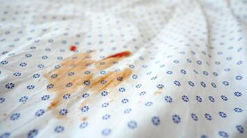 A stained bed sheet with visible spills and marks, showing issues with cleanliness video