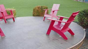 A set of colorful Adirondack Chairs arranged on a beautifully designed Circular Patio space video