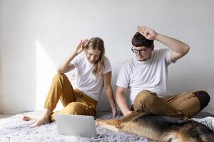 young woman and deaf man with audiology implant, having online call on laptop and gesturing photo