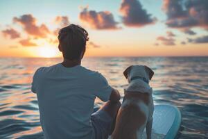 man sitting on sup board with golden retriever dog. photo
