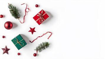 Top view layout with right blank space adorned pine tree branch, red ball, gift box, ribbon and star on white background like snow photo