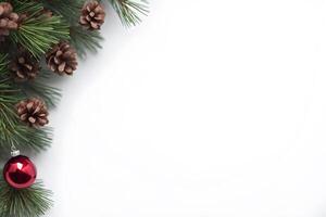 Top view layout with right blank space adorned pine tree branch decorative by pine cone and red shiny ball on white background like snow photo