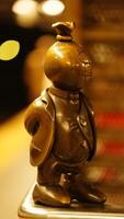 The cute little sculpture located in the New York subway station platform photo