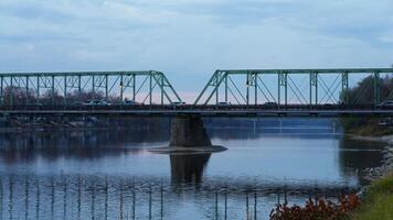 One old rion frames bridge view on the river with the sunset sky as background photo