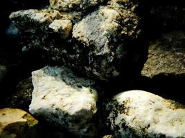 Abstract background with mountain rocks. Large shaped rocks that can be found on the shore of the sea, lake or river. photo