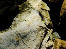 Abstract background with mountain rocks. Large shaped rocks that can be found on the shore of the sea, lake or river. photo