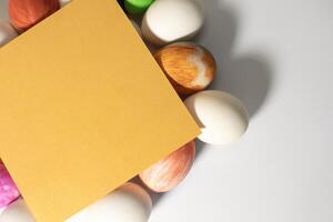Easter eggs and blank card on white background. photo