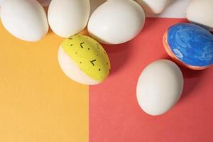 Easter holiday concept. Easter eggs on a red and yellow background with copy space photo