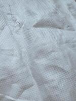 white sack texture and pattern. Arranged on a simple white background. For banners, website covers photo