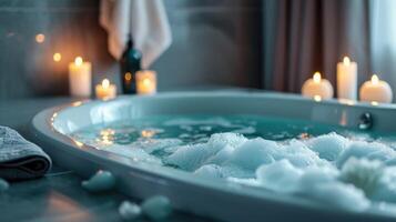 Luxury bathtub filled with water with foam and candles photo