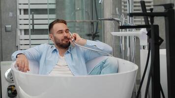 Funny man buyer imitates a phone call lying in a bath in a store video