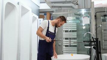 Salesman in uniform conducts inventory of baths in store video