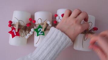 Step by step instruction of making handmade Christmas advent four weeks candle calendar. Female hands creating craft homemade decor. New year celebration. Winter holidays. Do it yourself video
